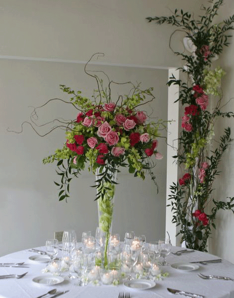 Table Covered with a Hanging Flower Installation Flowers submerged in a case filled with water and topped with floating candles wedding centerpiece ideas (Center pice forbid and groom table) Find this Pin and more on Wedding Ideas by ElegantWeddingInvites.